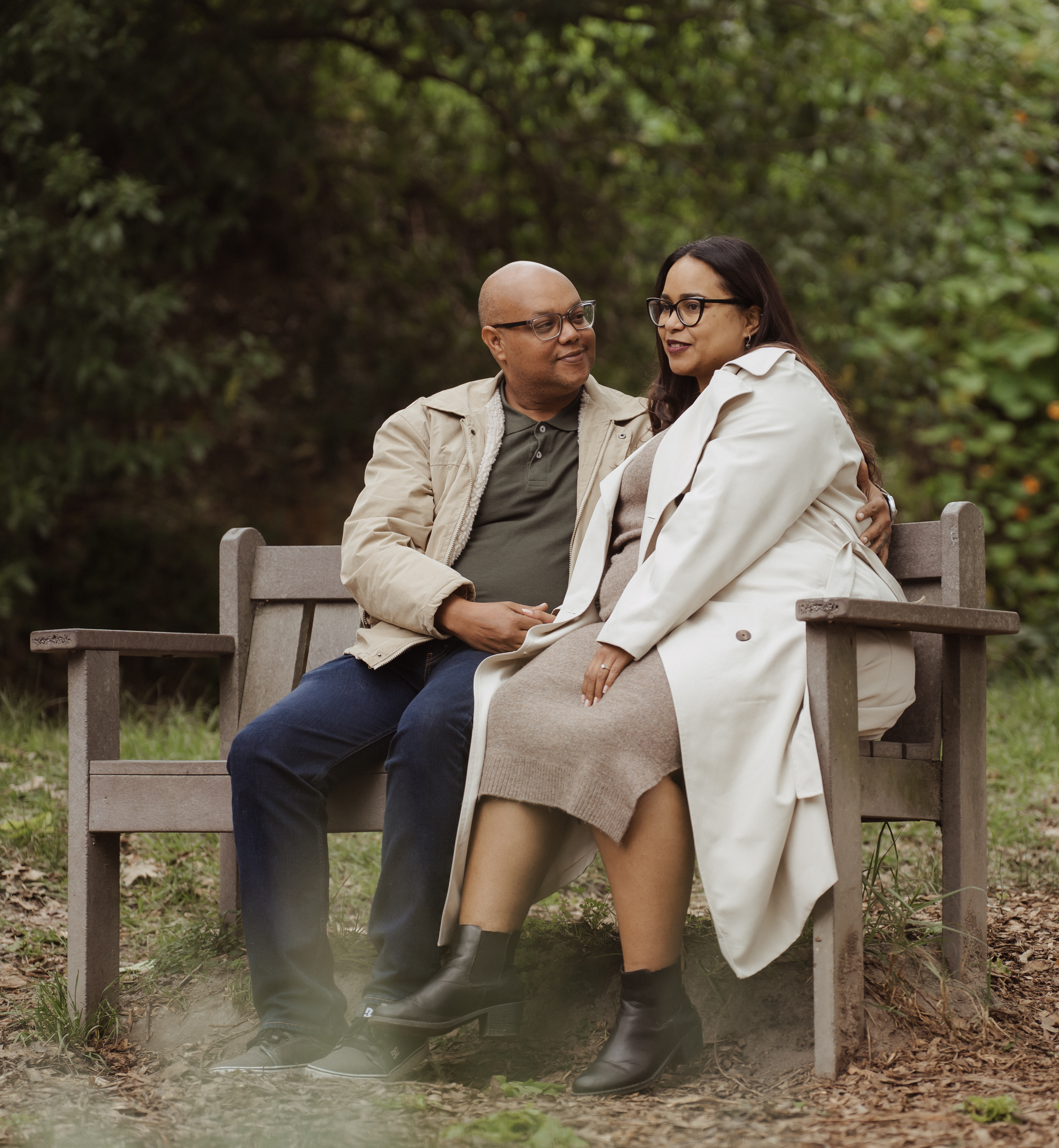 A couple seated together on a bench