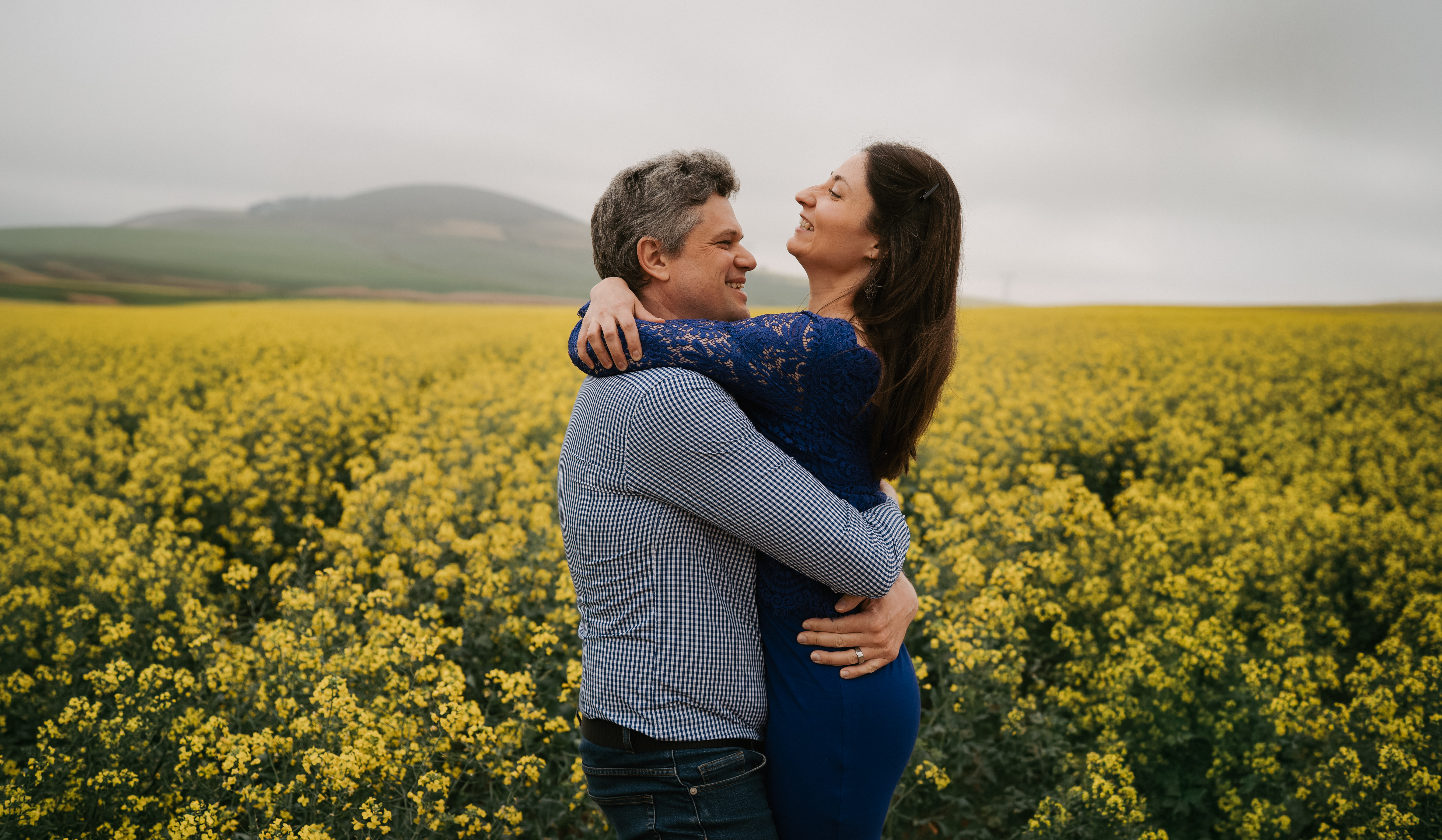 A couple embracing in a sunlit field