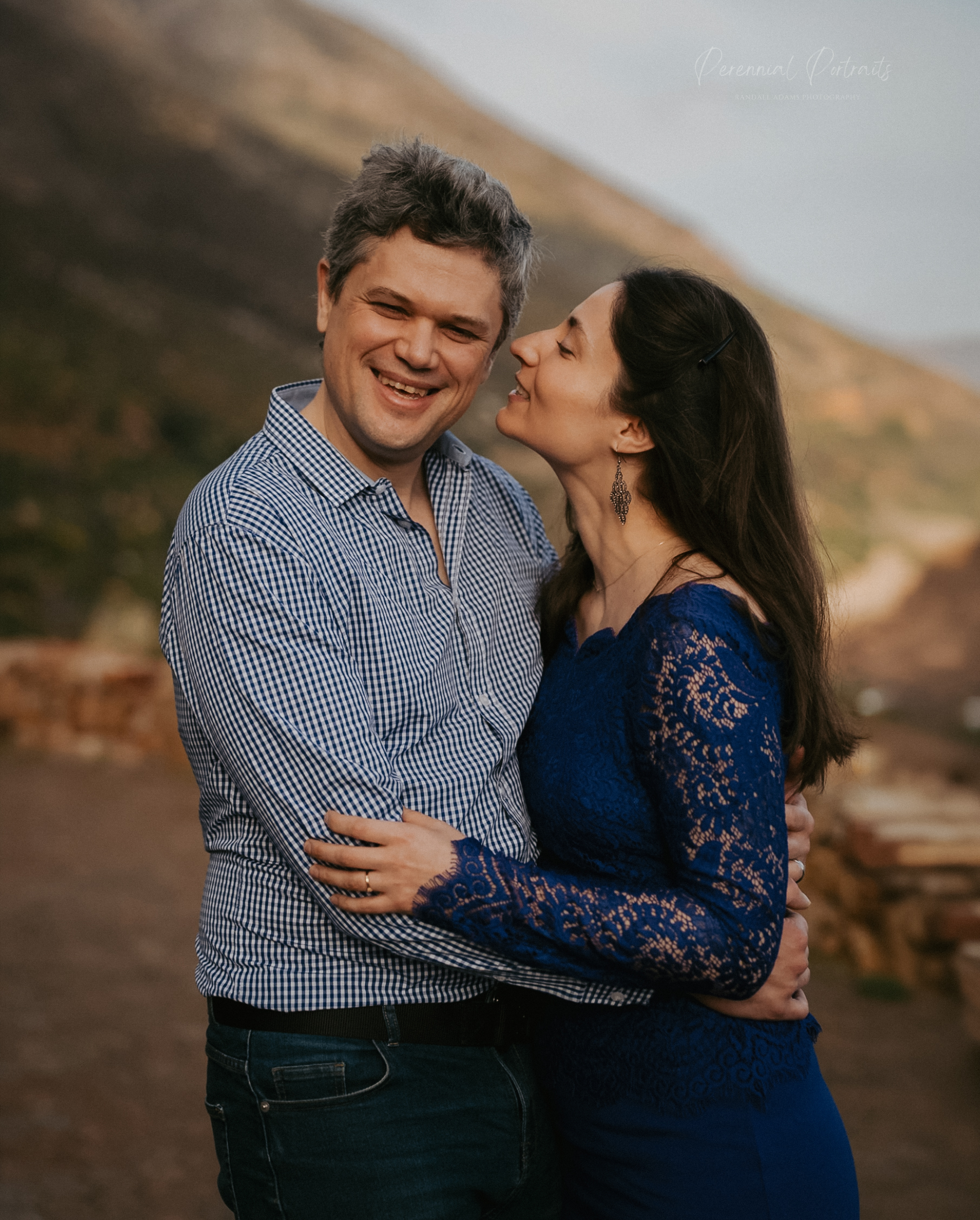 A couple laughing together outdoors