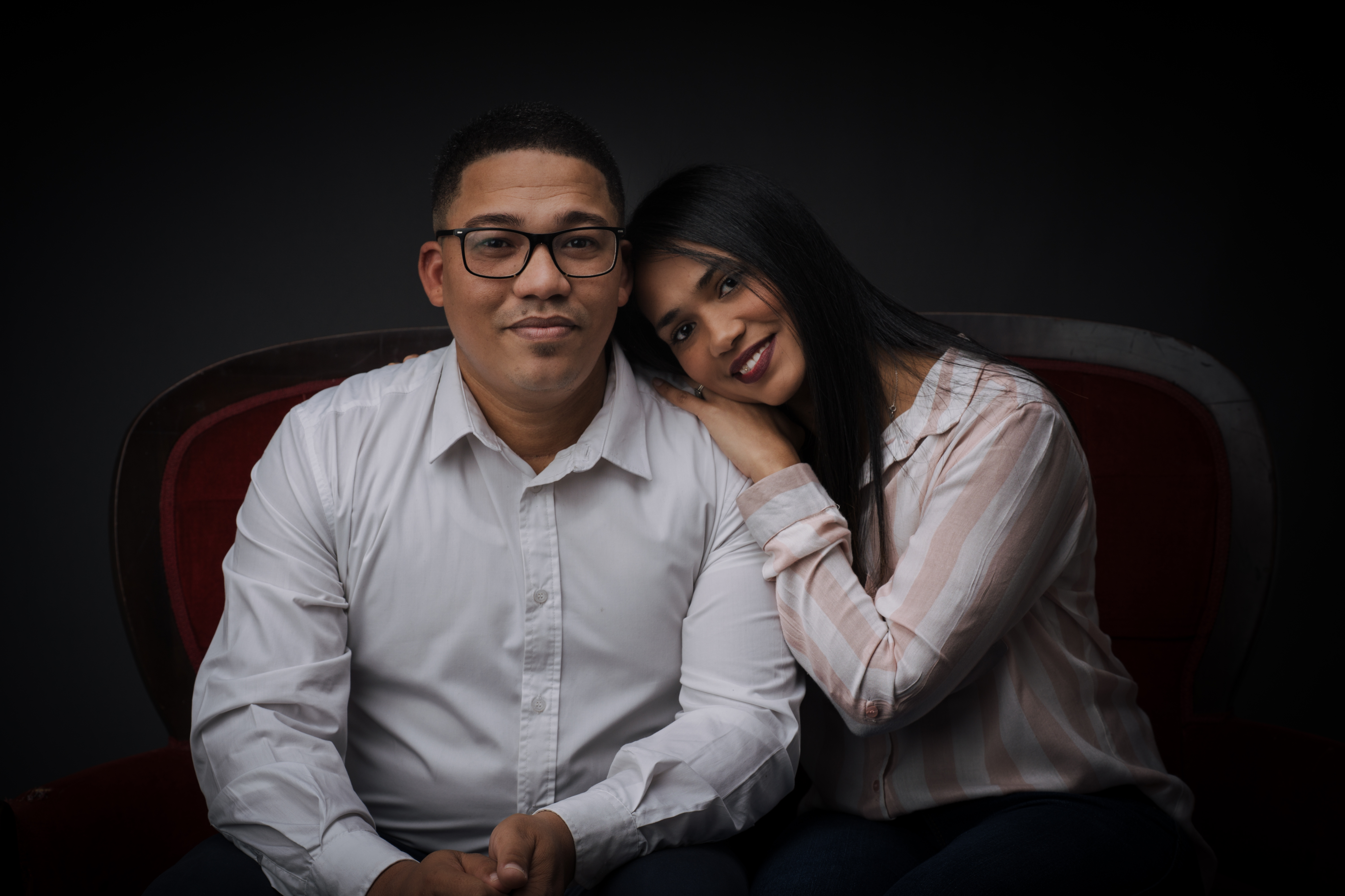 A couple seated together in the studio