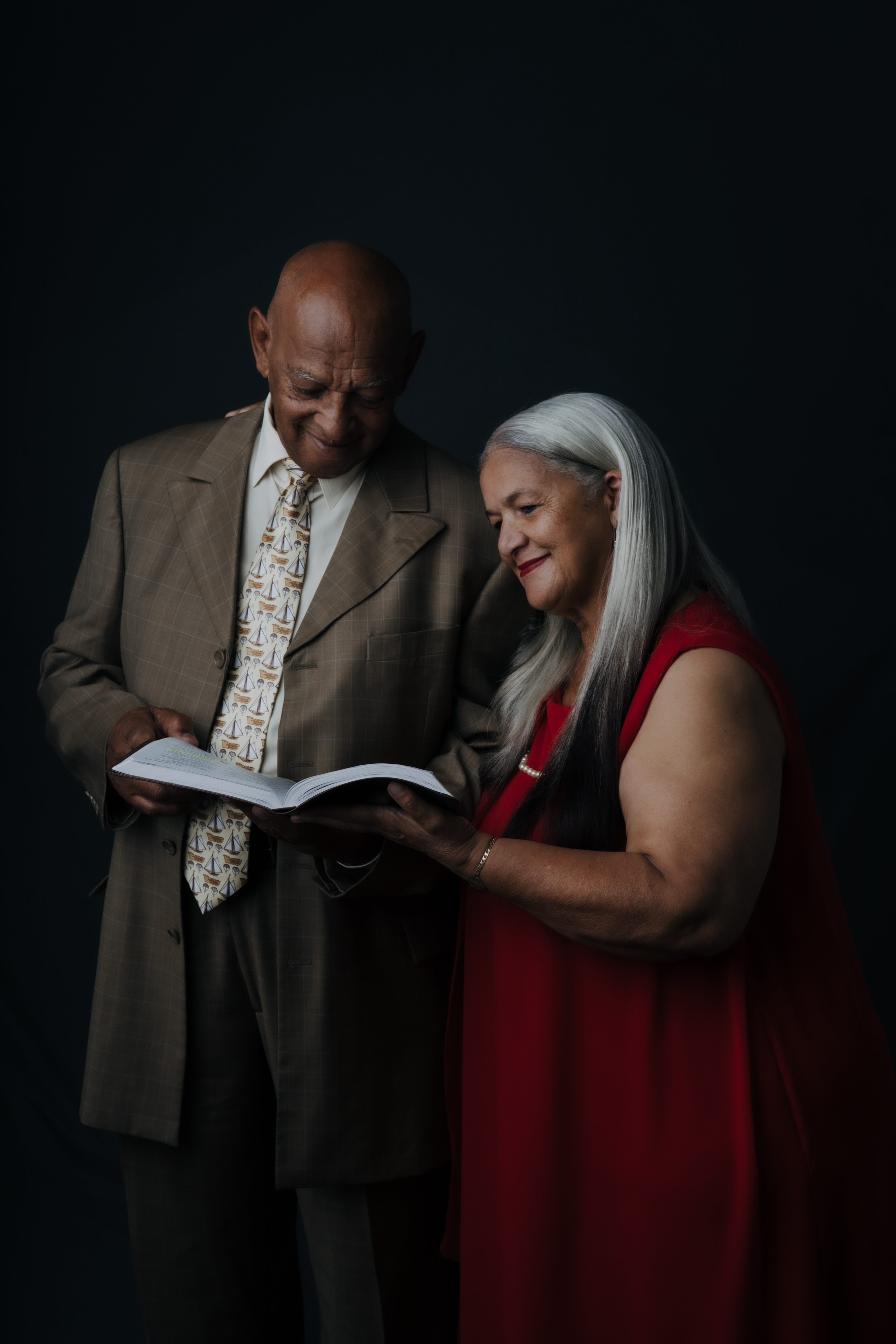 Older couple sharing a book in a studio portrait