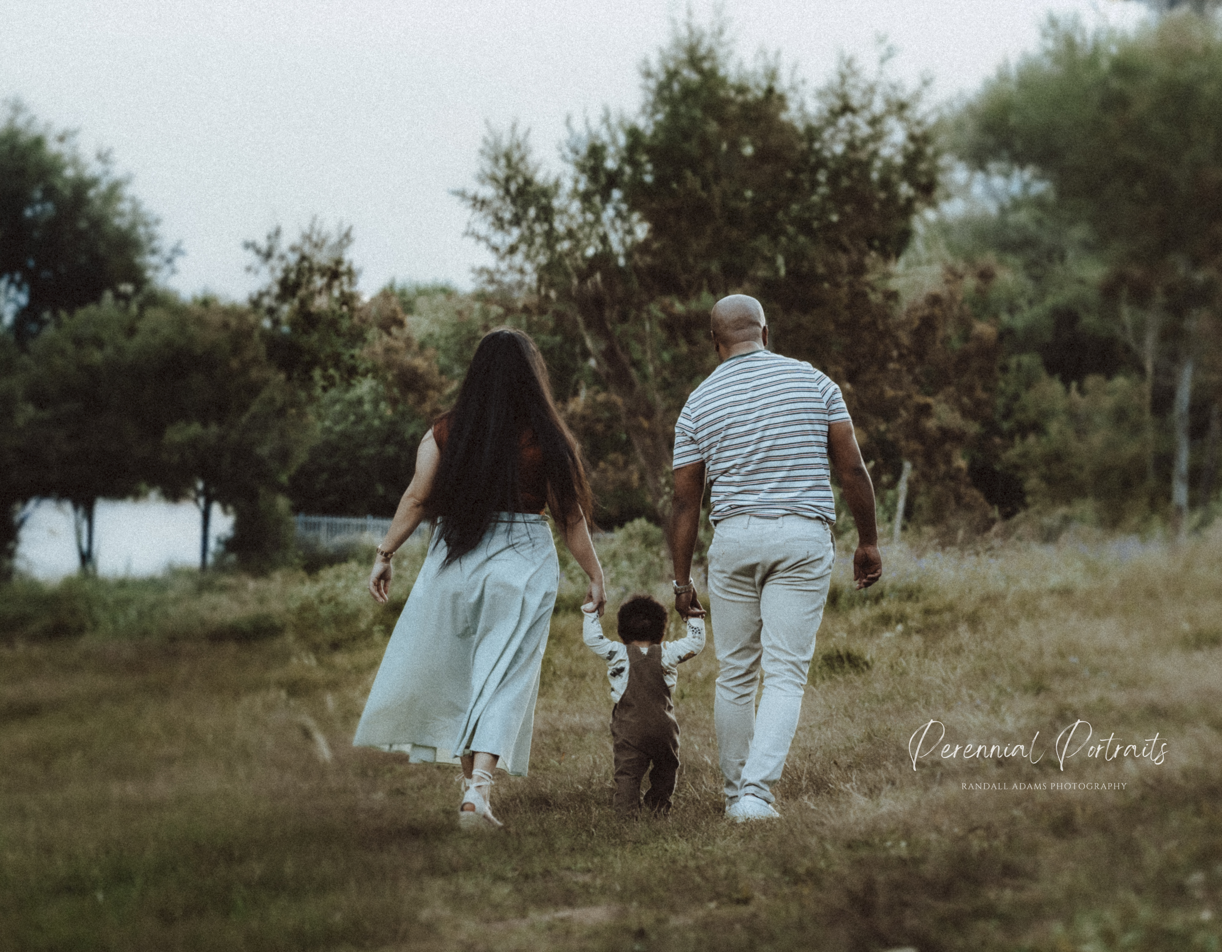 Parents walking with their child between them