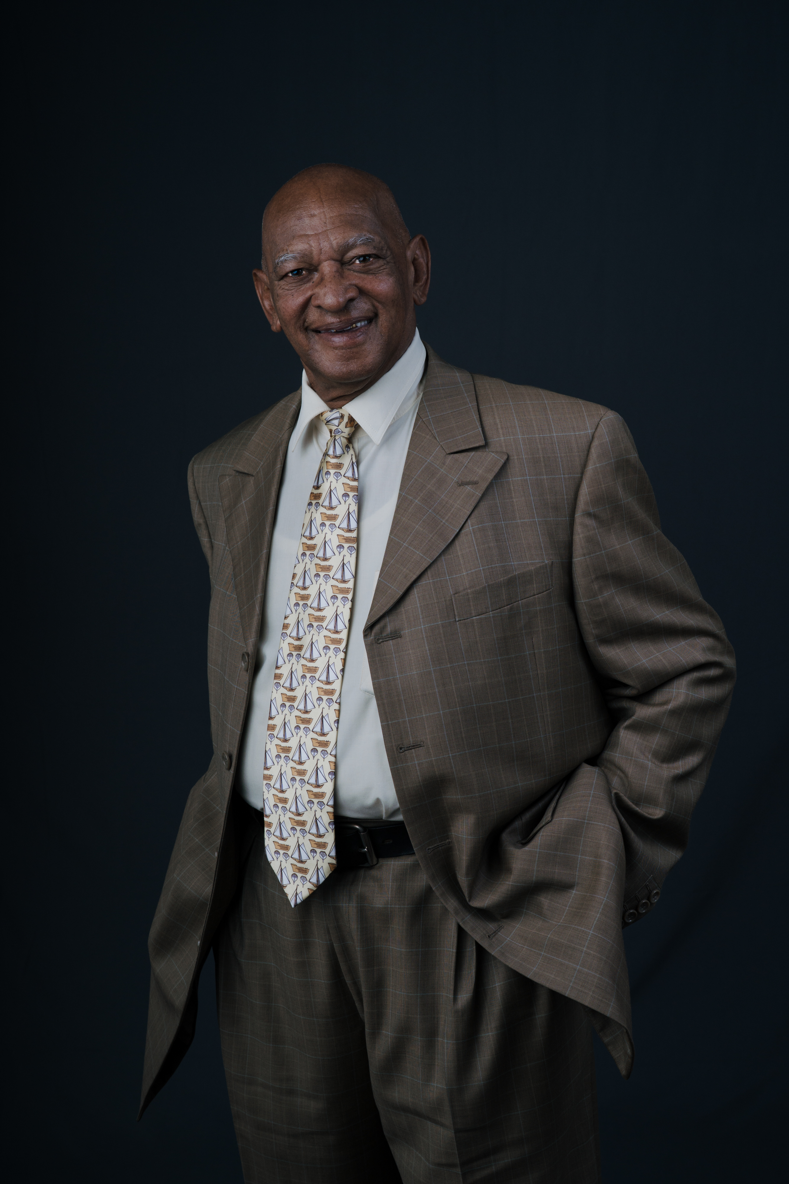 Studio portrait of a gentleman in a brown suit