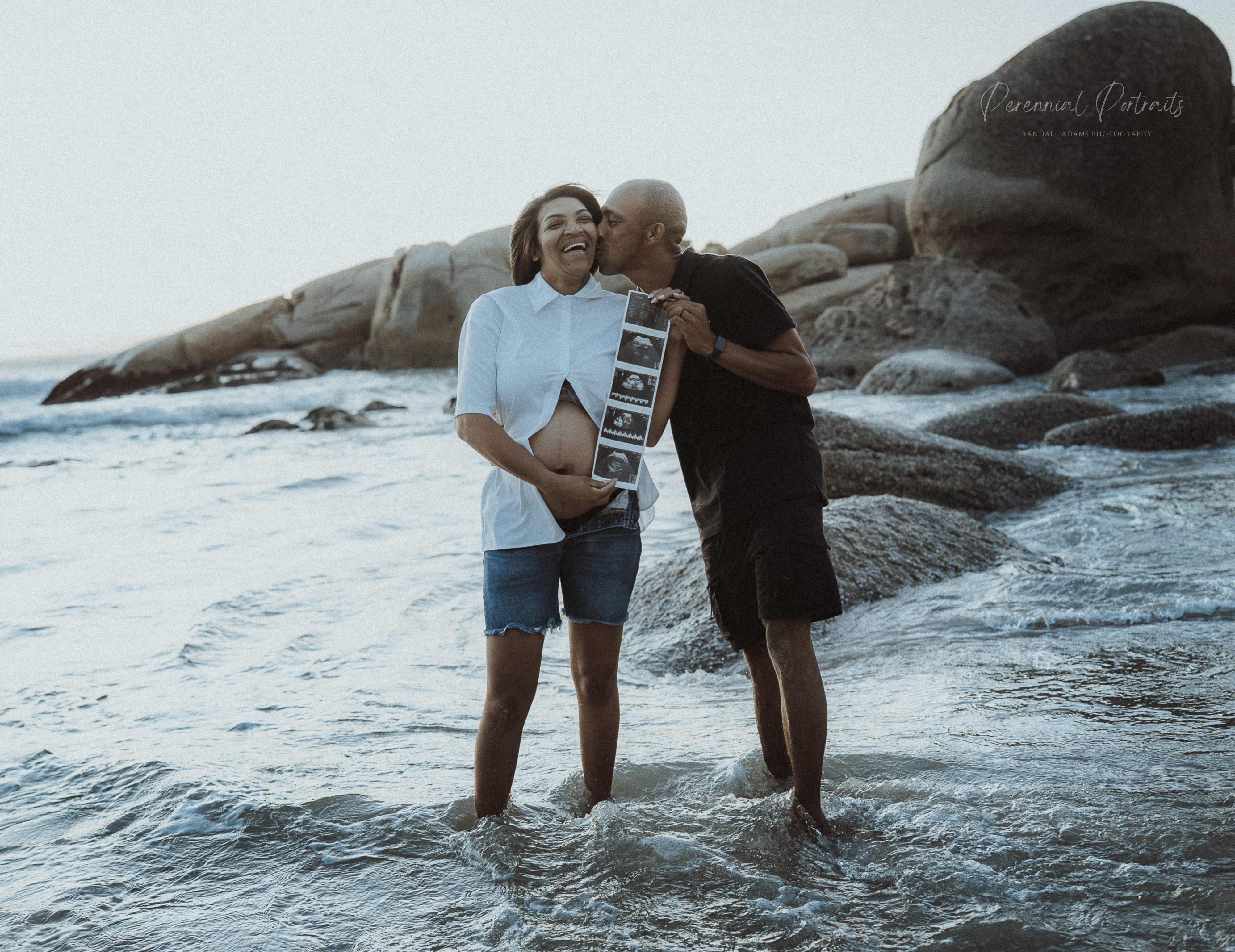 Maternity couple portrait by the beach